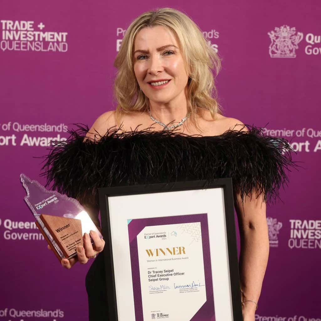 Dr Tracey Seipel holding awards for Seipel Group, winner of Women In International Business Award at Premier Of Queensland's Export Awards in 2024
