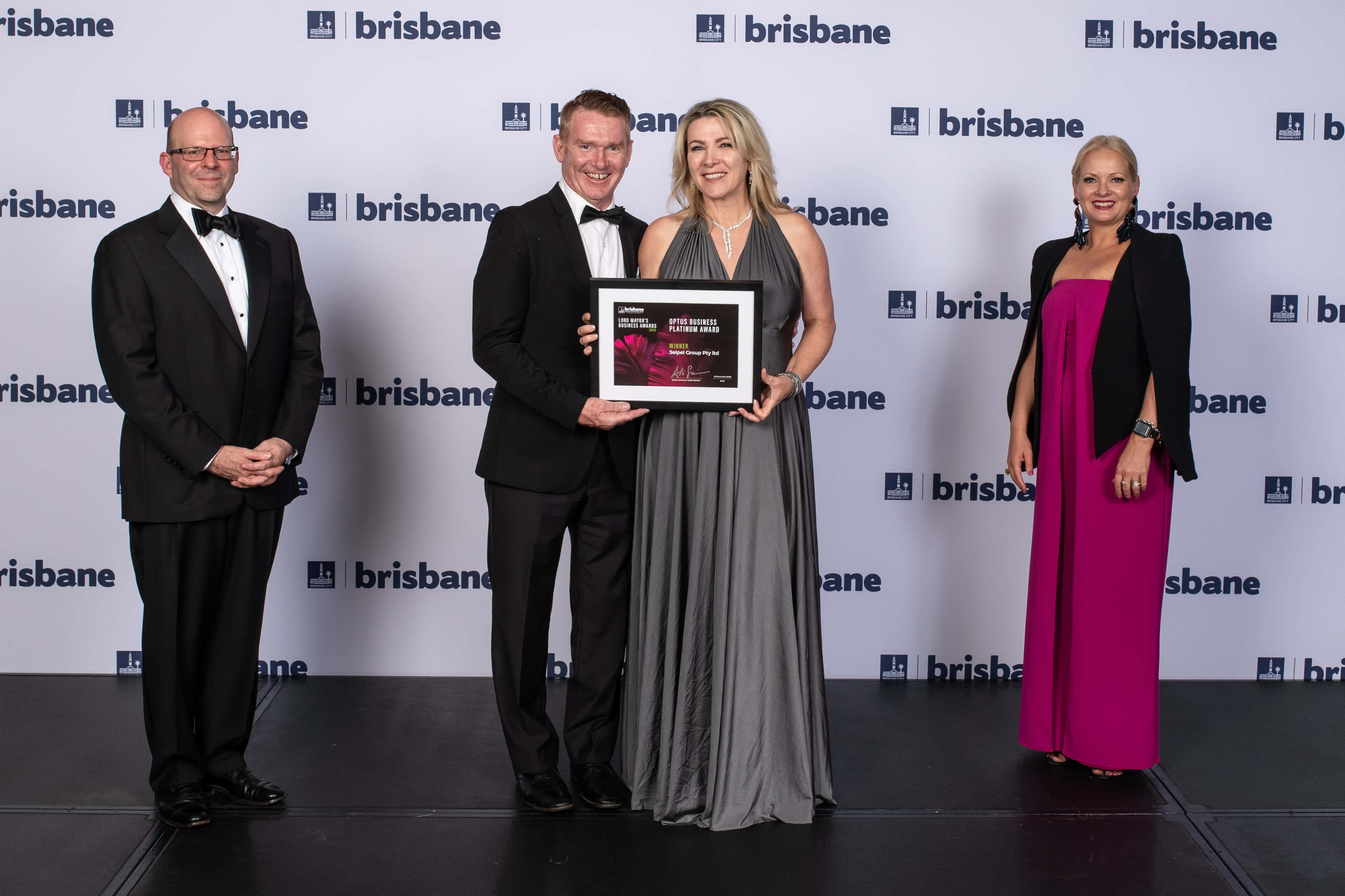Tracey Seipel and Patrick Coll on stage at the Lord Mayor's Business Awards, accepting award for Seipel Group, winner of the Australia Pacific LNG Award for Business Innovation.