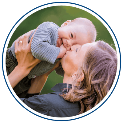 Photo of mother holding and kissing baby
